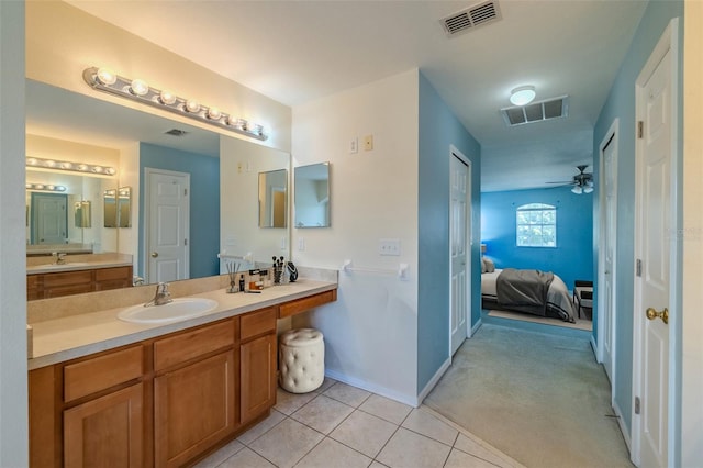 7852 Stoney Hill Dr, Wesley Chapel, FL 33545 - ensuite bathroom with vanity, tile patterned flooring, baseboards, and ceiling fan