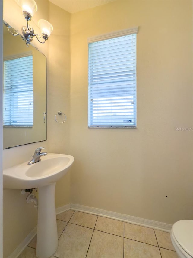 7852 Stoney Hill Dr, Wesley Chapel, FL 33545 - half bathroom featuring tile patterned floors, toilet, and baseboards