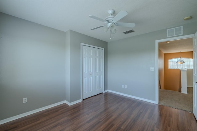 7852 Stoney Hill Dr, Wesley Chapel, FL 33545 - unfurnished bedroom with dark wood finished floors, baseboards, a closet, and ceiling fan