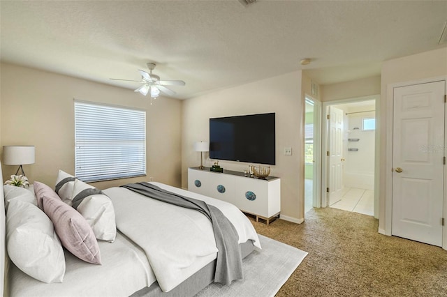7852 Stoney Hill Dr, Wesley Chapel, FL 33545 - carpeted bedroom featuring multiple windows, ceiling fan, and ensuite bathroom