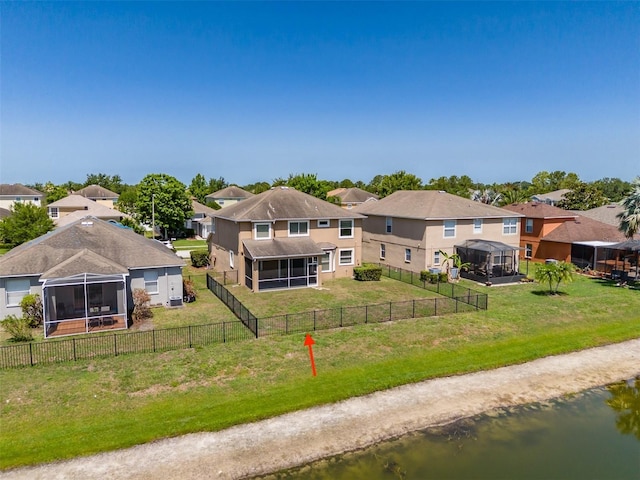 7852 Stoney Hill Dr, Wesley Chapel, FL 33545 - back of house featuring a sunroom, a residential view, stucco siding, and a water view