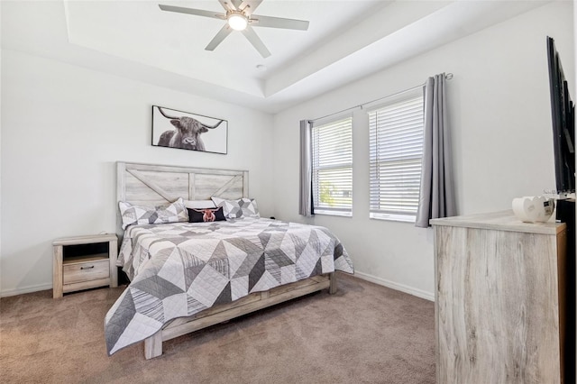 8496 Starlight Loop, Parrish, FL 34219 - carpeted bedroom featuring baseboards, a raised ceiling, and a ceiling fan