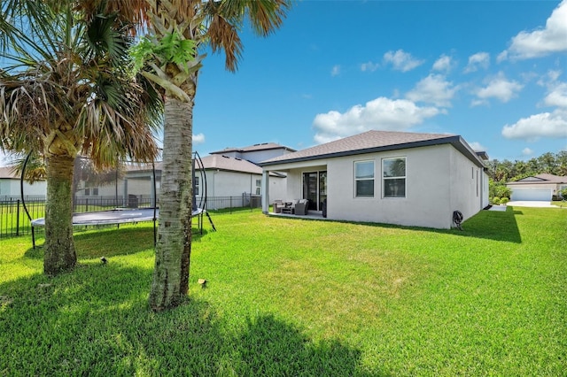 8496 Starlight Loop, Parrish, FL 34219 - back of house with a trampoline and stucco siding