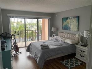 51 Island Way Unit 309, Clearwater Beach, FL 33767 - bedroom featuring wood finished floors and access to outside