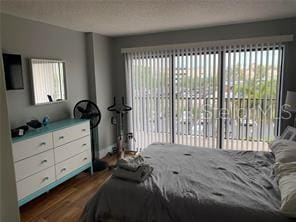51 Island Way Unit 309, Clearwater Beach, FL 33767 - bedroom with dark wood-style flooring and multiple windows