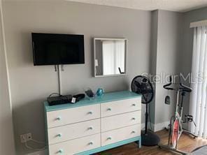 51 Island Way Unit 309, Clearwater Beach, FL 33767 - bedroom featuring dark wood finished floors and baseboards