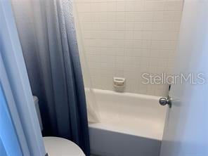 51 Island Way Unit 309, Clearwater Beach, FL 33767 - bathroom with toilet and shower / bath combo with shower curtain