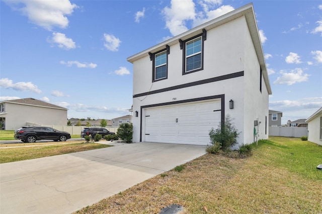 view of front of property with driveway, stucco siding, and a garage