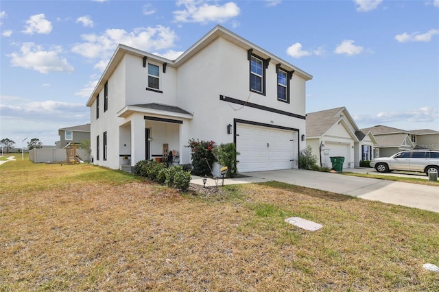 view of front of house featuring stucco siding, an attached garage, concrete driveway, and a front yard