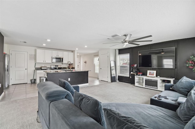 living room with light tile patterned floors, ceiling fan, light colored carpet, and recessed lighting
