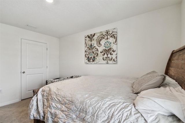 carpeted bedroom featuring baseboards