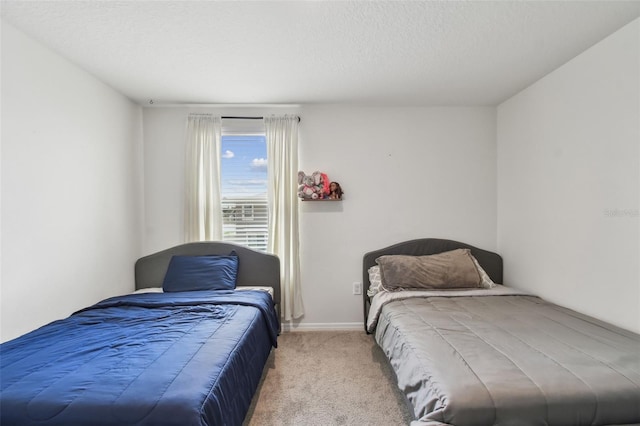 bedroom with carpet floors, a textured ceiling, and baseboards