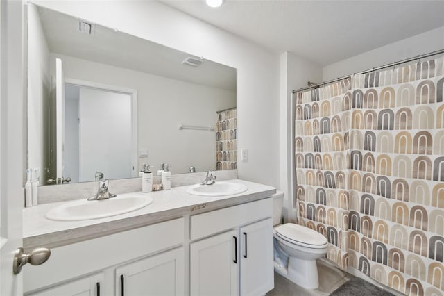 bathroom featuring toilet, double vanity, and curtained shower