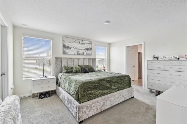 carpeted bedroom featuring a textured ceiling