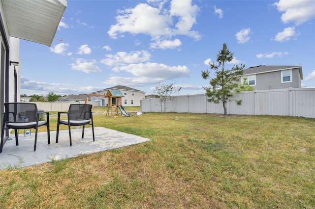 view of yard featuring a patio area and a playground