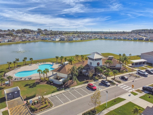 aerial view of a pool area and a large body of water