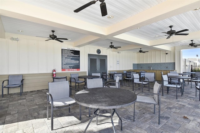 view of patio / terrace featuring a ceiling fan, french doors, and outdoor dining area