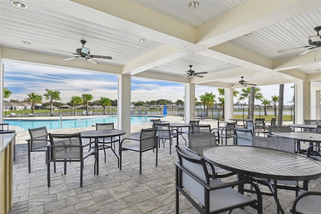 view of patio / terrace with ceiling fan and a community pool