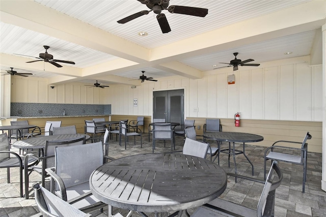 view of patio featuring outdoor dining space, a ceiling fan, and french doors