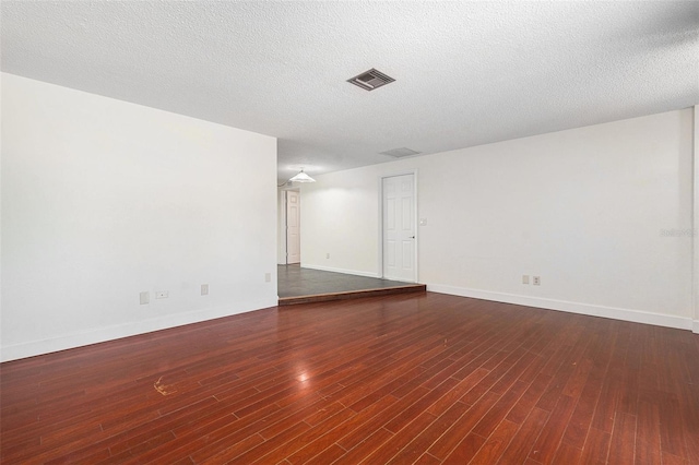 12019 106th Ct, Largo, FL 33778 - unfurnished room featuring wood finished floors and a textured ceiling