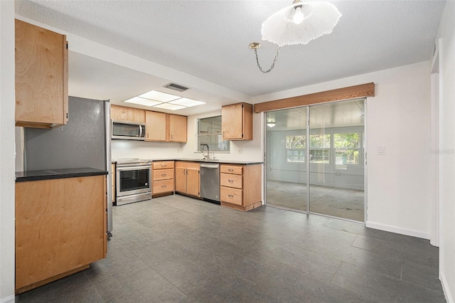 12019 106th Ct, Largo, FL 33778 - kitchen with appliances with stainless steel finishes and baseboards