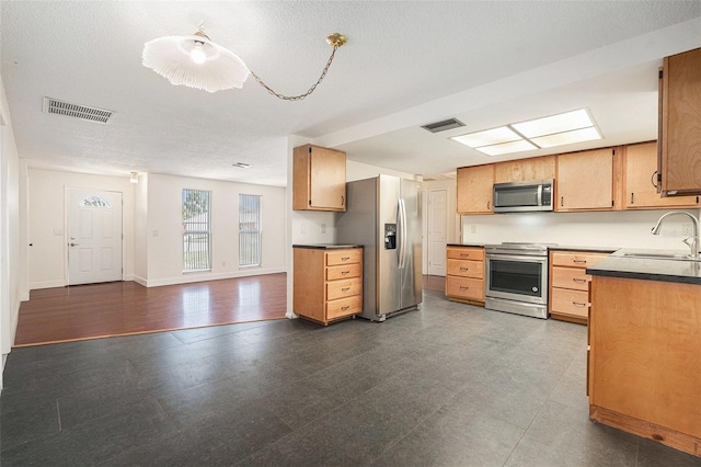12019 106th Ct, Largo, FL 33778 - kitchen with stainless steel appliances, open floor plan, and dark countertops