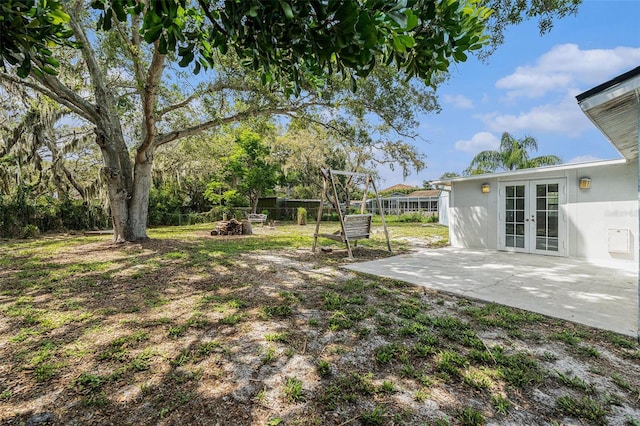 12019 106th Ct, Largo, FL 33778 - view of yard with french doors, a patio area, and a fire pit