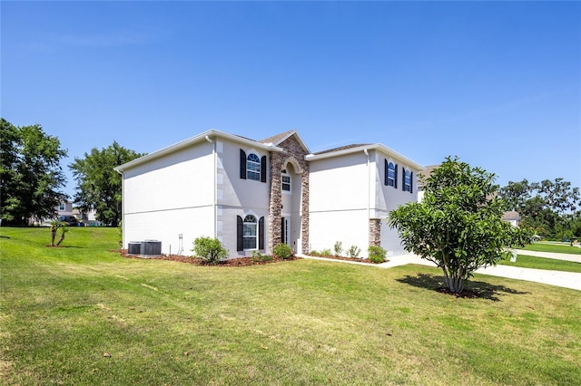 14384 NW 160th Ln, Alachua, FL 32615 - view of front of property featuring stucco siding, cooling unit, a front lawn, and stone siding