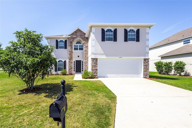14384 NW 160th Ln, Alachua, FL 32615 - traditional-style home with stone siding, stucco siding, concrete driveway, an attached garage, and a front lawn