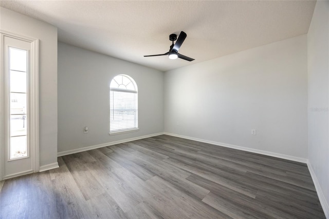 14384 NW 160th Ln, Alachua, FL 32615 - spare room with a ceiling fan, dark wood-type flooring, and baseboards