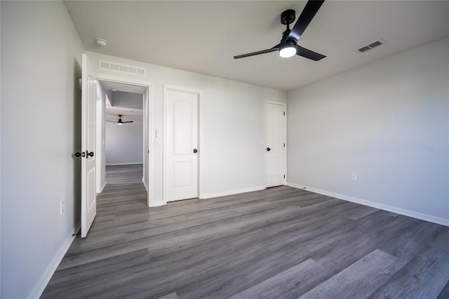 14384 NW 160th Ln, Alachua, FL 32615 - unfurnished bedroom with baseboards, dark wood-style flooring, and a ceiling fan