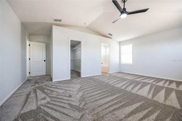 14384 NW 160th Ln, Alachua, FL 32615 - unfurnished bedroom with vaulted ceiling, carpet floors, a walk in closet, baseboards, and a closet