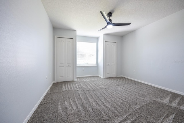 14384 NW 160th Ln, Alachua, FL 32615 - unfurnished bedroom with carpet, two closets, baseboards, a textured ceiling, and ceiling fan