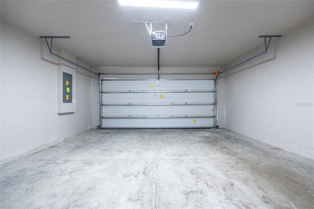 14384 NW 160th Ln, Alachua, FL 32615 - garage with a garage door opener, electric panel, and concrete block wall