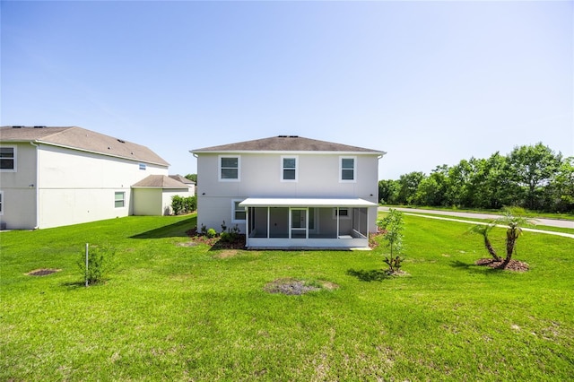 14384 NW 160th Ln, Alachua, FL 32615 - rear view of house with a sunroom, a yard, and stucco siding