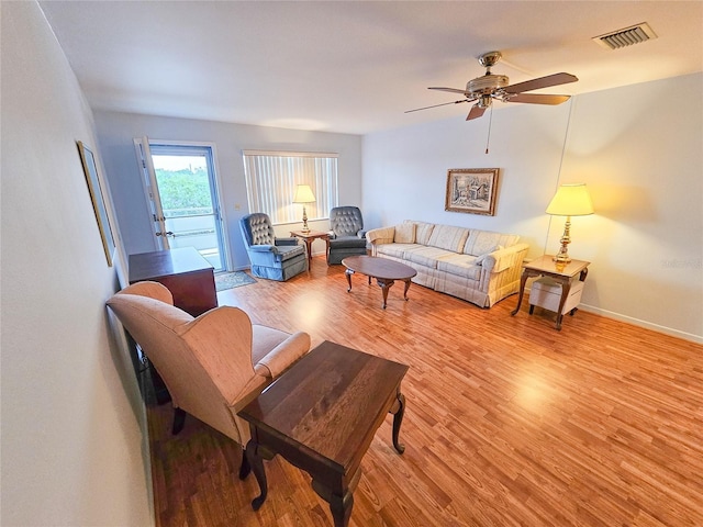 2850 59th St S Unit 310, Gulfport, FL 33707 - living area with light wood-type flooring, ceiling fan, and baseboards