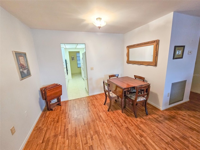 2850 59th St S Unit 310, Gulfport, FL 33707 - dining room featuring light wood-type flooring and baseboards