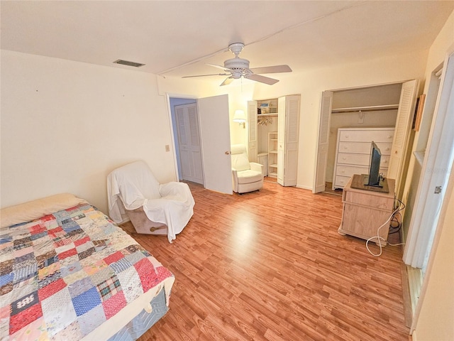 2850 59th St S Unit 310, Gulfport, FL 33707 - bedroom featuring light wood finished floors, multiple closets, and a ceiling fan