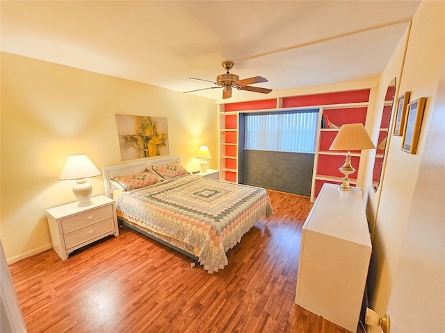 2850 59th St S Unit 310, Gulfport, FL 33707 - bedroom with wood finished floors, a ceiling fan, and baseboards
