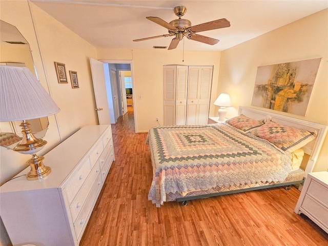 2850 59th St S Unit 310, Gulfport, FL 33707 - bedroom with light wood-style flooring, a closet, and ceiling fan