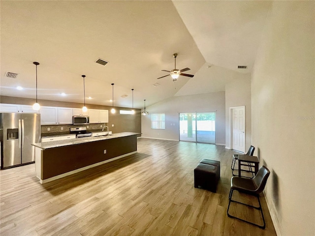 6376 SW 117th Street Rd, Ocala, FL 34476 - kitchen featuring stainless steel appliances, a sink, baseboards, light wood-type flooring, and open floor plan