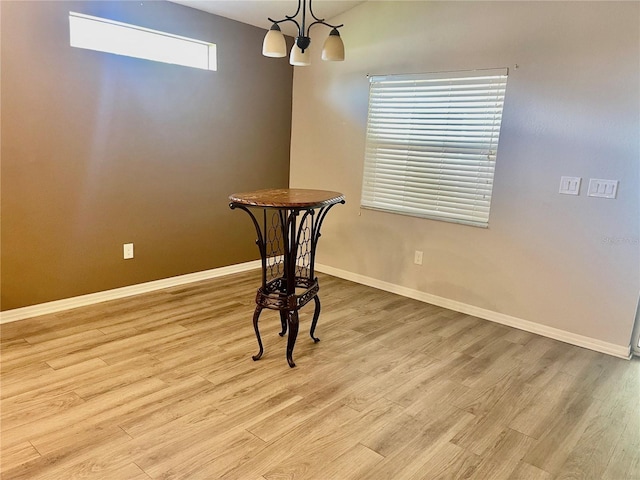 6376 SW 117th Street Rd, Ocala, FL 34476 - unfurnished room featuring wood finished floors, baseboards, and a chandelier