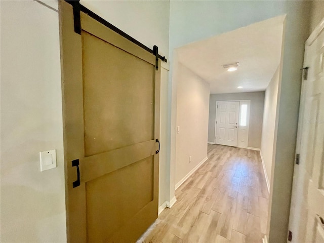 6376 SW 117th Street Rd, Ocala, FL 34476 - hall with a barn door, light wood finished floors, and baseboards