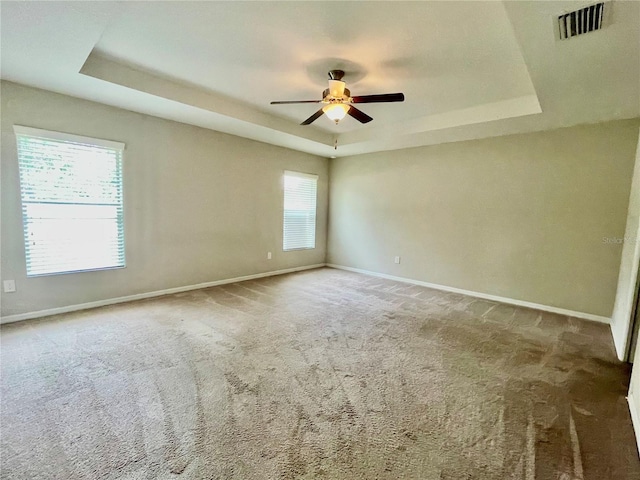 6376 SW 117th Street Rd, Ocala, FL 34476 - carpeted empty room featuring a tray ceiling, ceiling fan, and baseboards