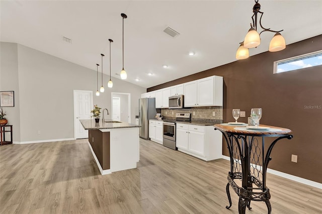 6376 SW 117th Street Rd, Ocala, FL 34476 - kitchen featuring appliances with stainless steel finishes, light wood-type flooring, white cabinets, and high vaulted ceiling
