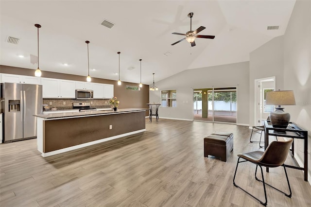 6376 SW 117th Street Rd, Ocala, FL 34476 - kitchen featuring appliances with stainless steel finishes, high vaulted ceiling, a ceiling fan, white cabinetry, and a kitchen island with sink