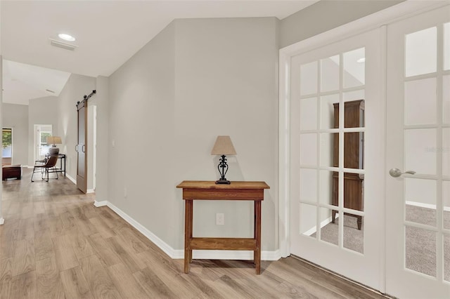 6376 SW 117th Street Rd, Ocala, FL 34476 - hall with a barn door and light wood-type flooring