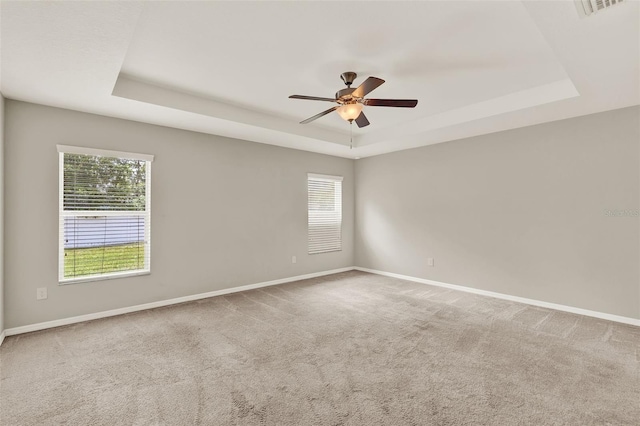 6376 SW 117th Street Rd, Ocala, FL 34476 - carpeted spare room featuring a tray ceiling, plenty of natural light, and ceiling fan