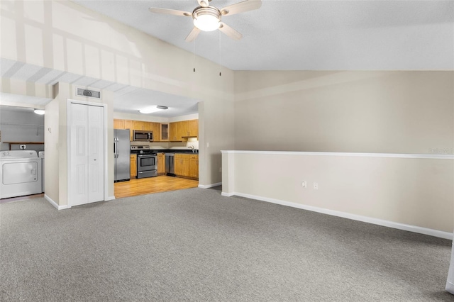 10511 Waterview Ct Unit 10511, Tampa, FL 33615 - unfurnished living room with washing machine and dryer, light colored carpet, a ceiling fan, vaulted ceiling, and baseboards