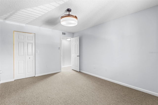 10511 Waterview Ct Unit 10511, Tampa, FL 33615 - unfurnished bedroom featuring carpet floors, baseboards, a closet, and a textured ceiling